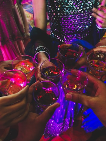 A festive group raising glasses in a toast during a lively event night