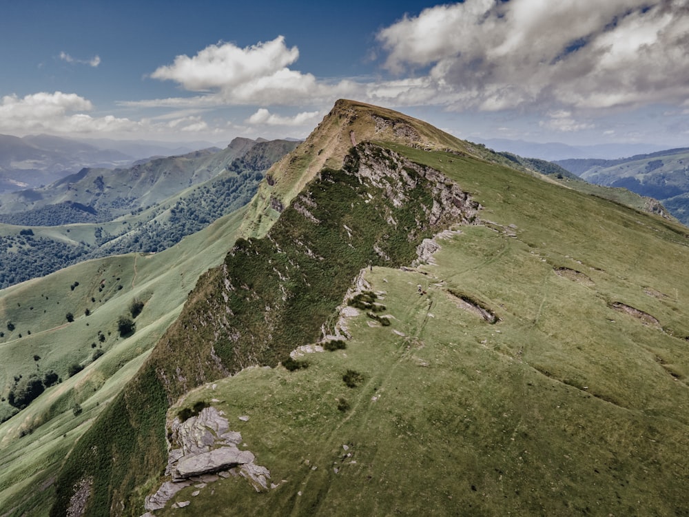 an aerial view of a green mountain range