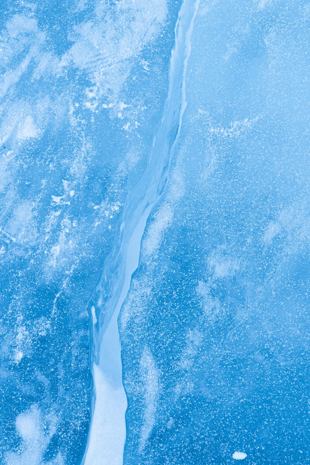 an aerial view of a frozen river and ice