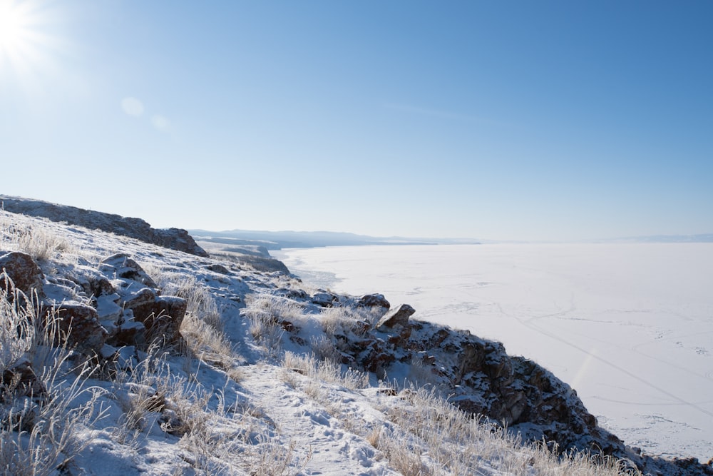 the sun shines brightly over a snowy landscape