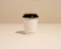 Minimalist coffee cup on a beige linen cloth with soft morning light.