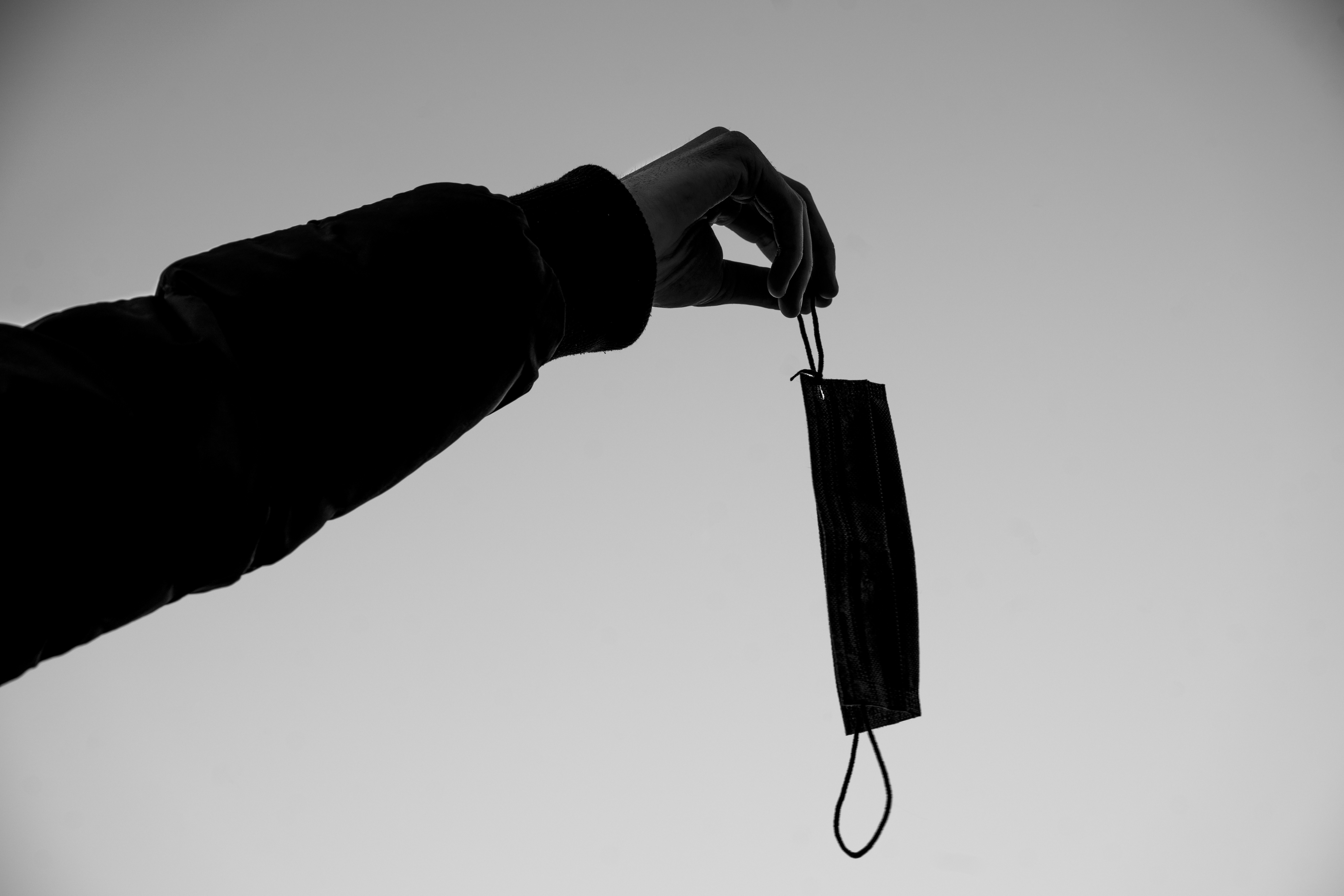 a black and white photo of a person holding an umbrella