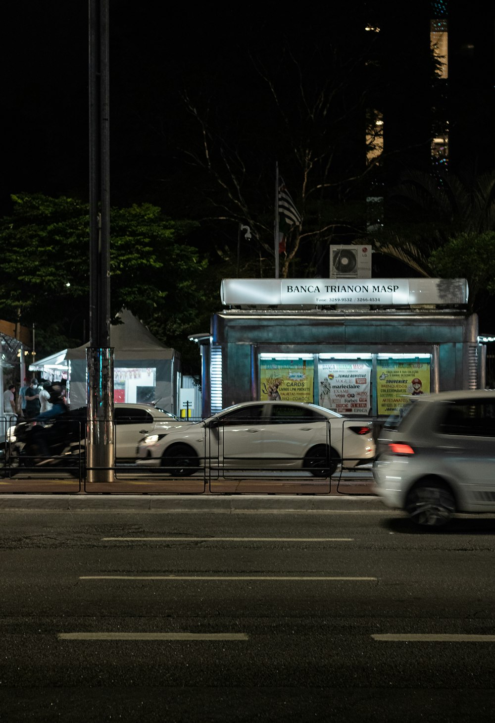 a car driving down a street at night