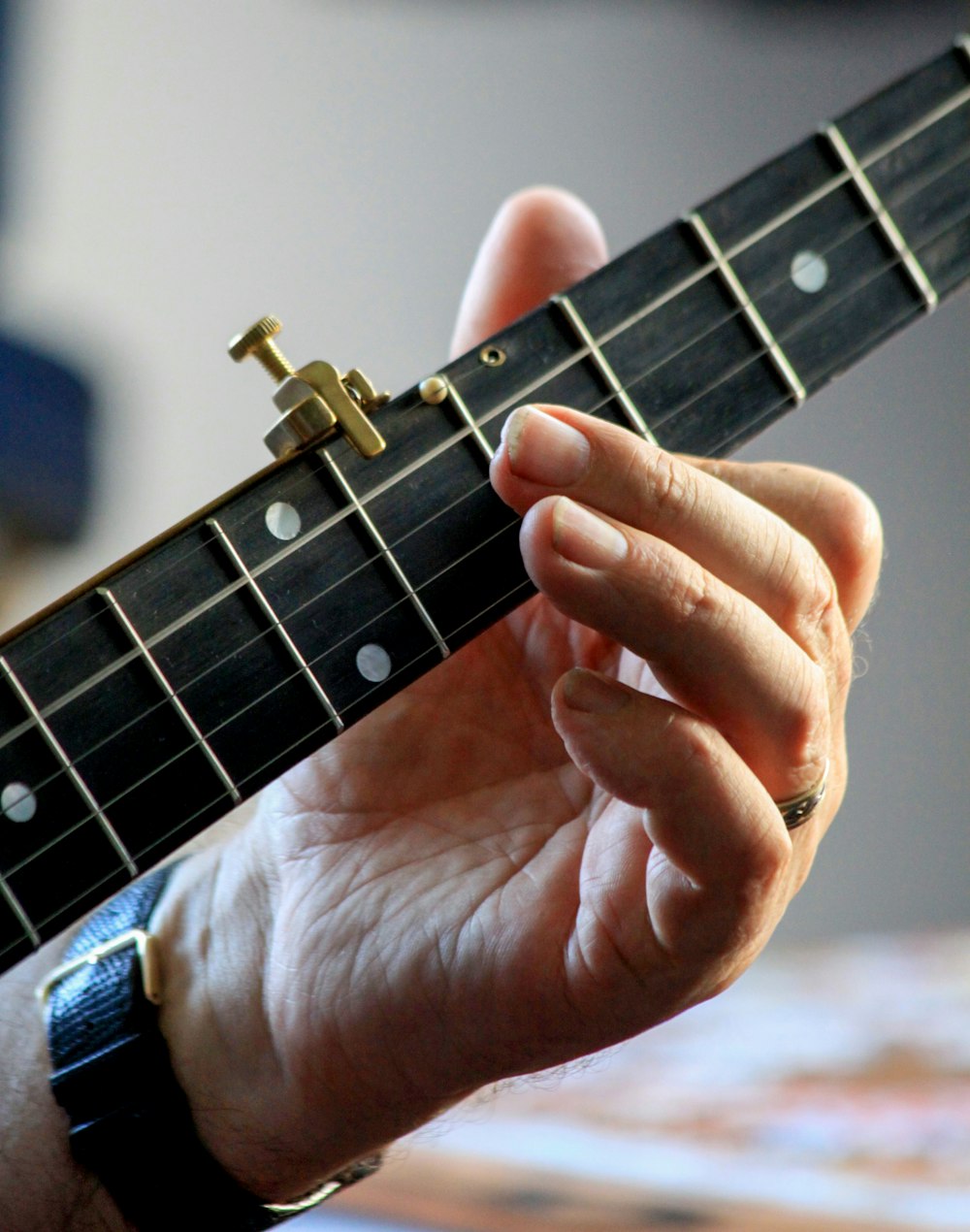 a close up of a person holding a guitar