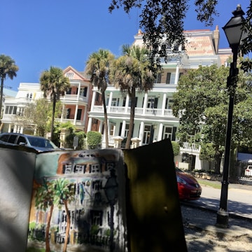 An original painting showing a sleepy LA suburb with vintage cars and palm trees under a bright sky.
