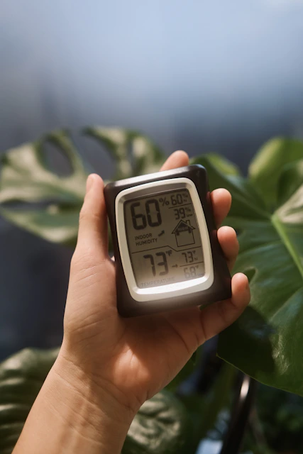 a person holding a digital clock in their hand