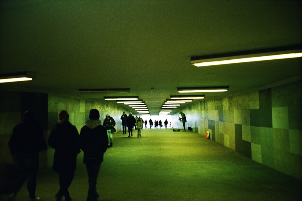 a group of people walking through a tunnel