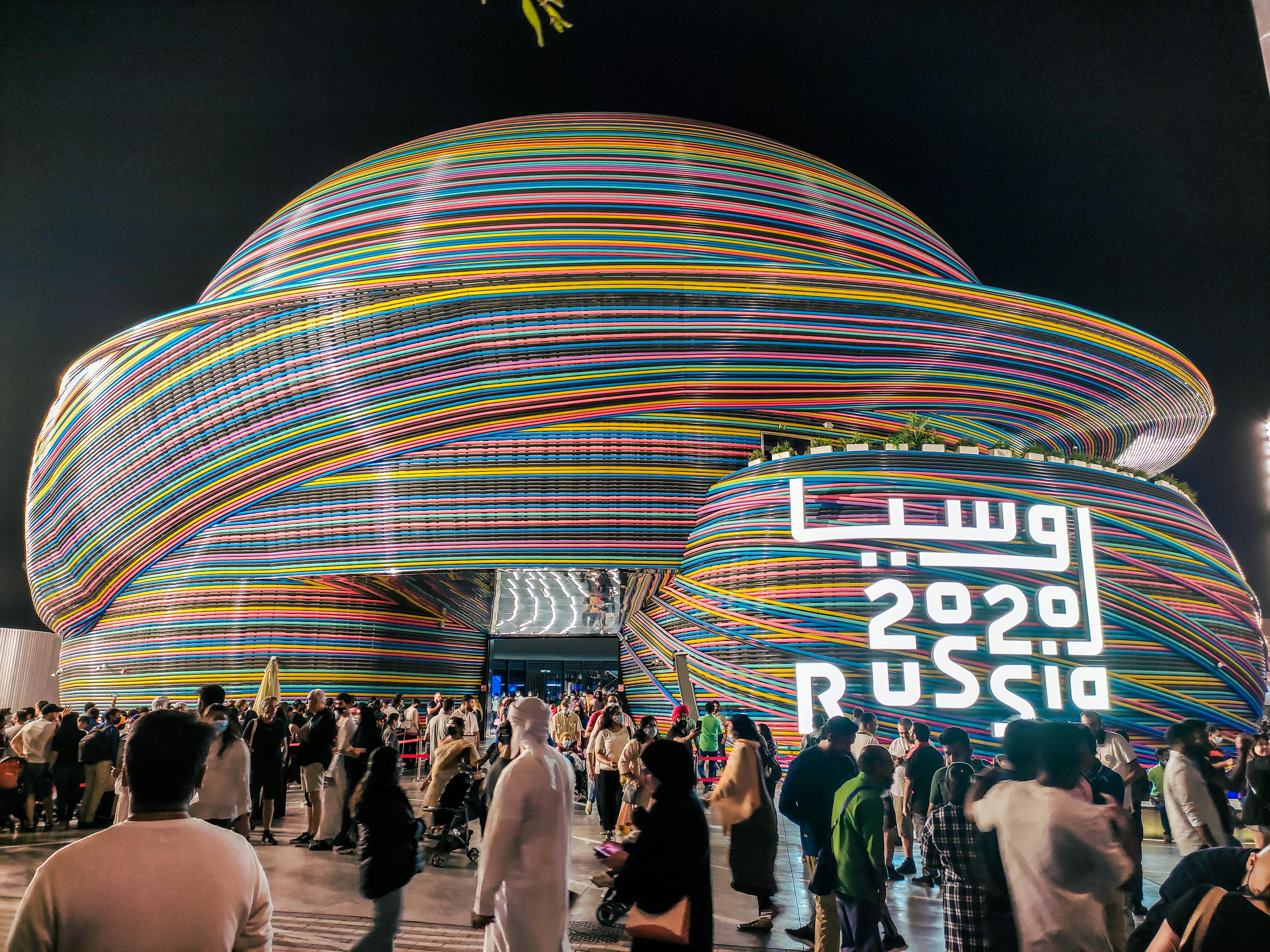 a large crowd of people standing around a building
