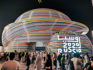 a large crowd of people standing around a building