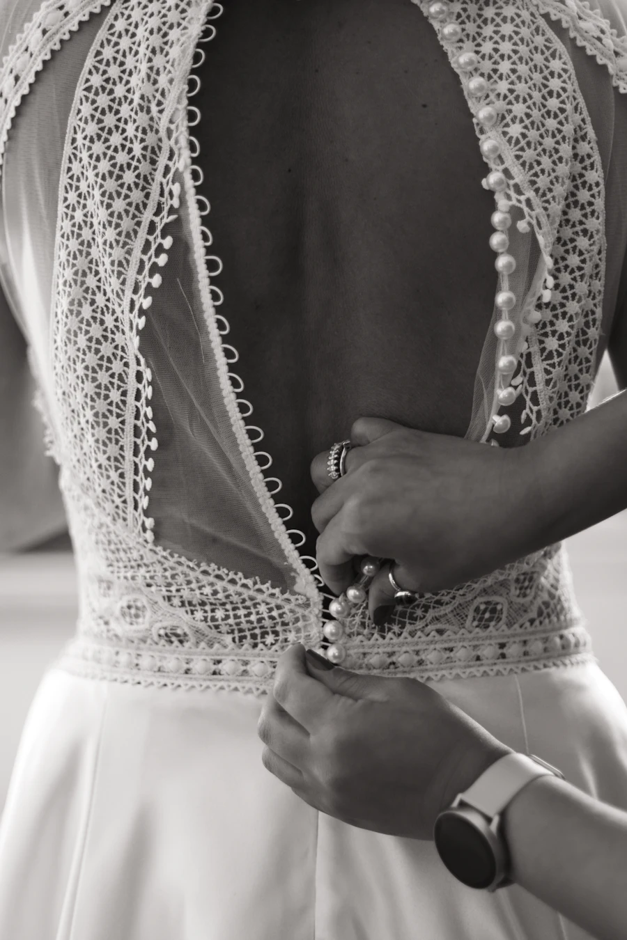 Wedding dress hanging in soft studio light