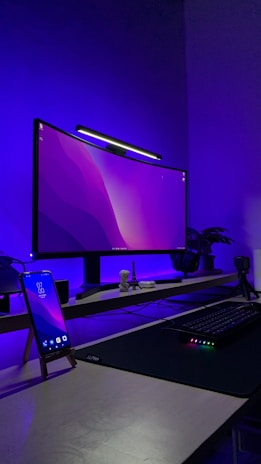 a desk with a phone and a computer on it