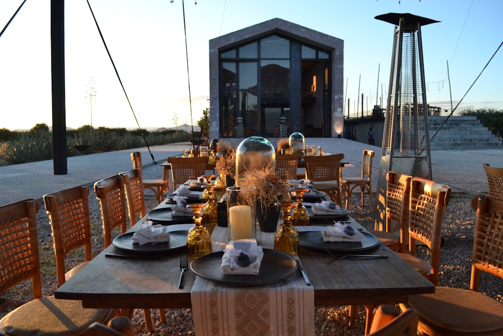 a table set for a dinner outside at dusk