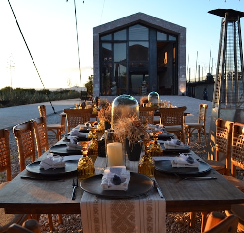 a table set for a dinner outside at dusk