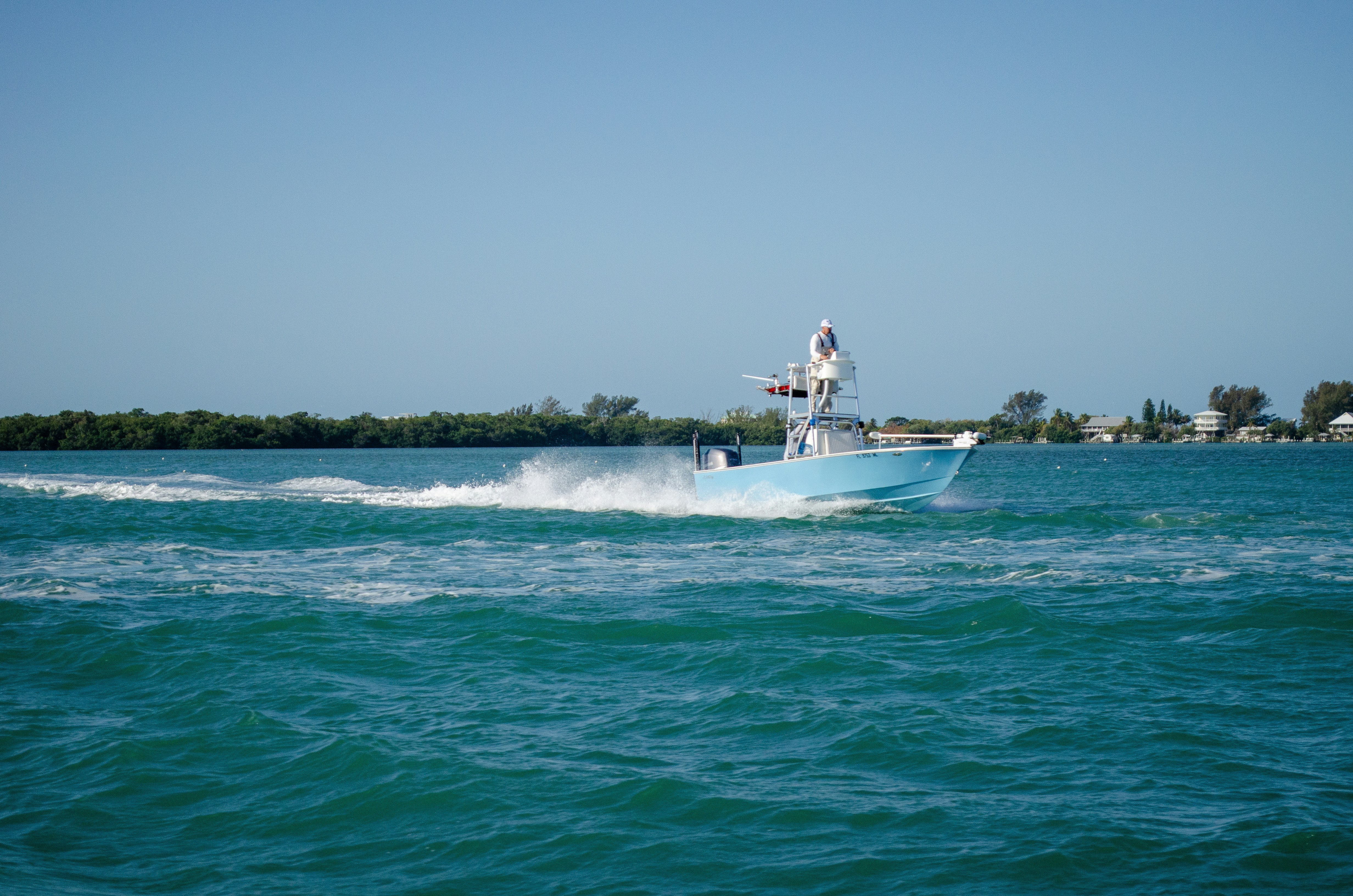 a man on a boat in the middle of the ocean