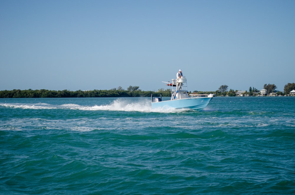 a man on a boat in the middle of the ocean