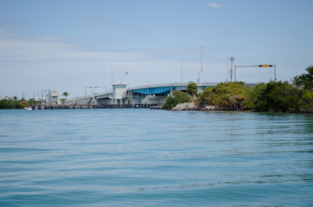 a body of water with a bridge in the background