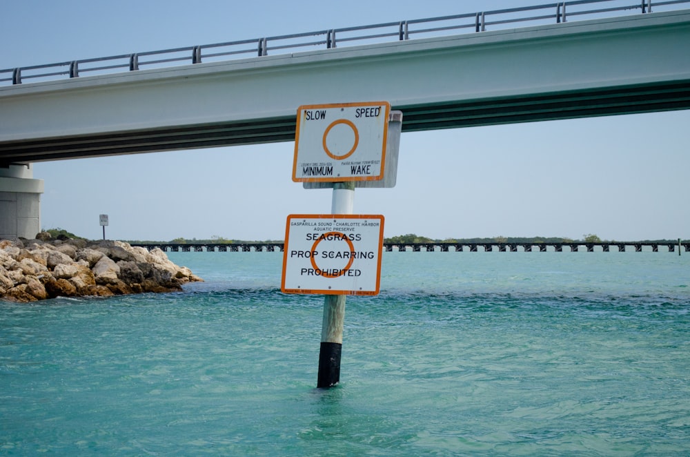 a couple of signs that are in the water