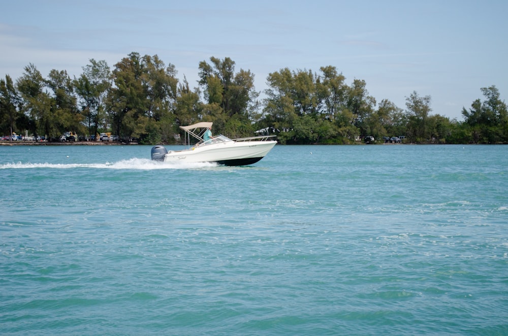 a small boat traveling across a large body of water