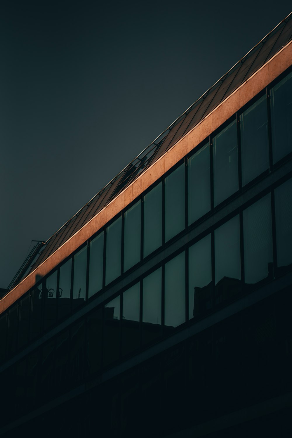 an airplane flying over a building at night