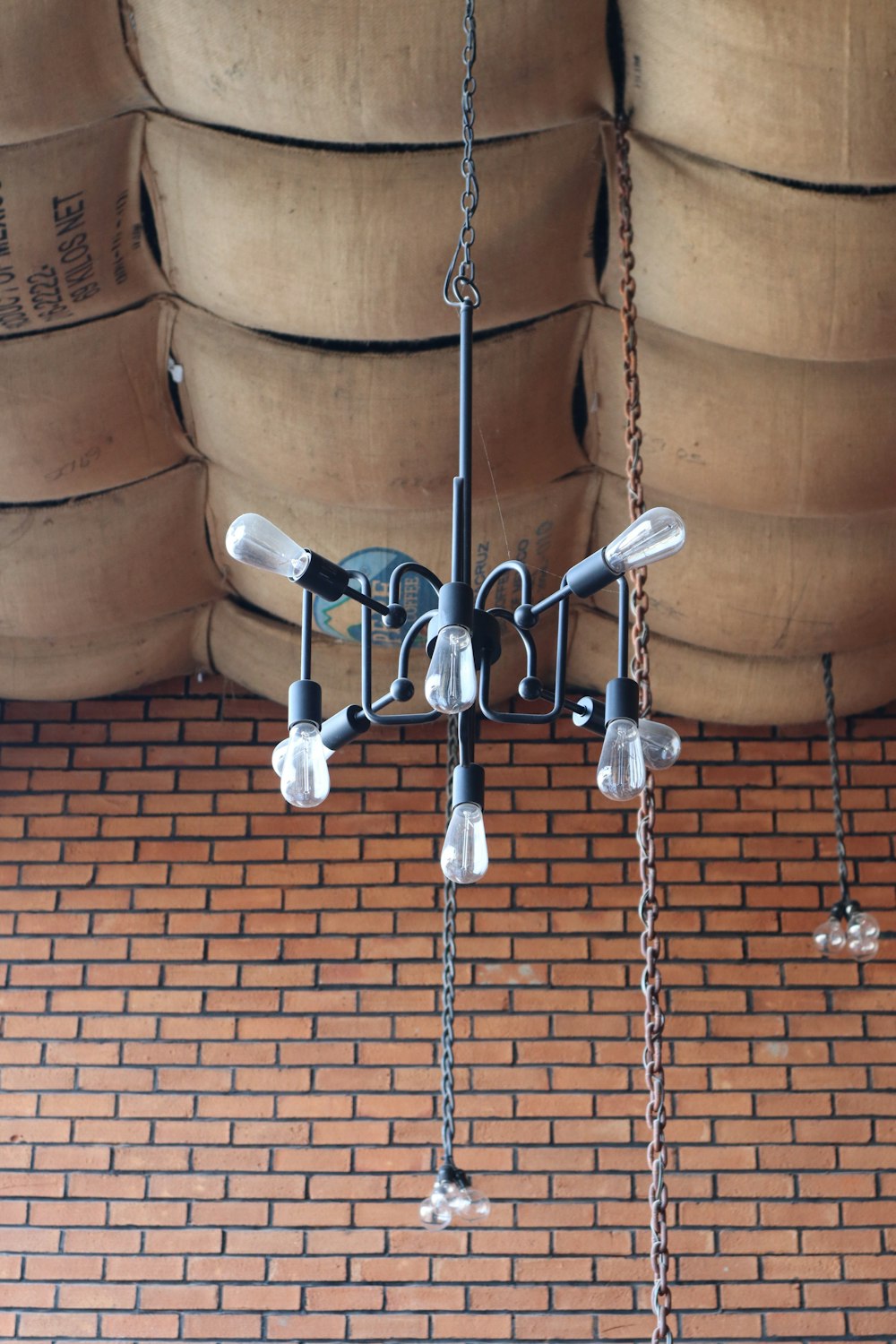 a chandelier hanging from a brick ceiling