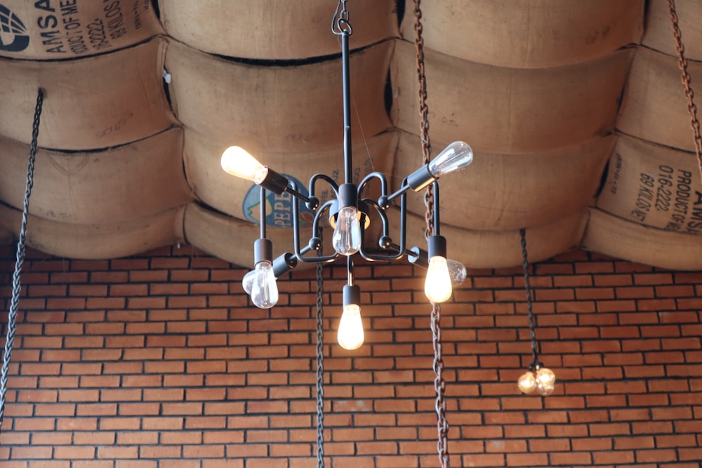 a chandelier hanging from a brick ceiling