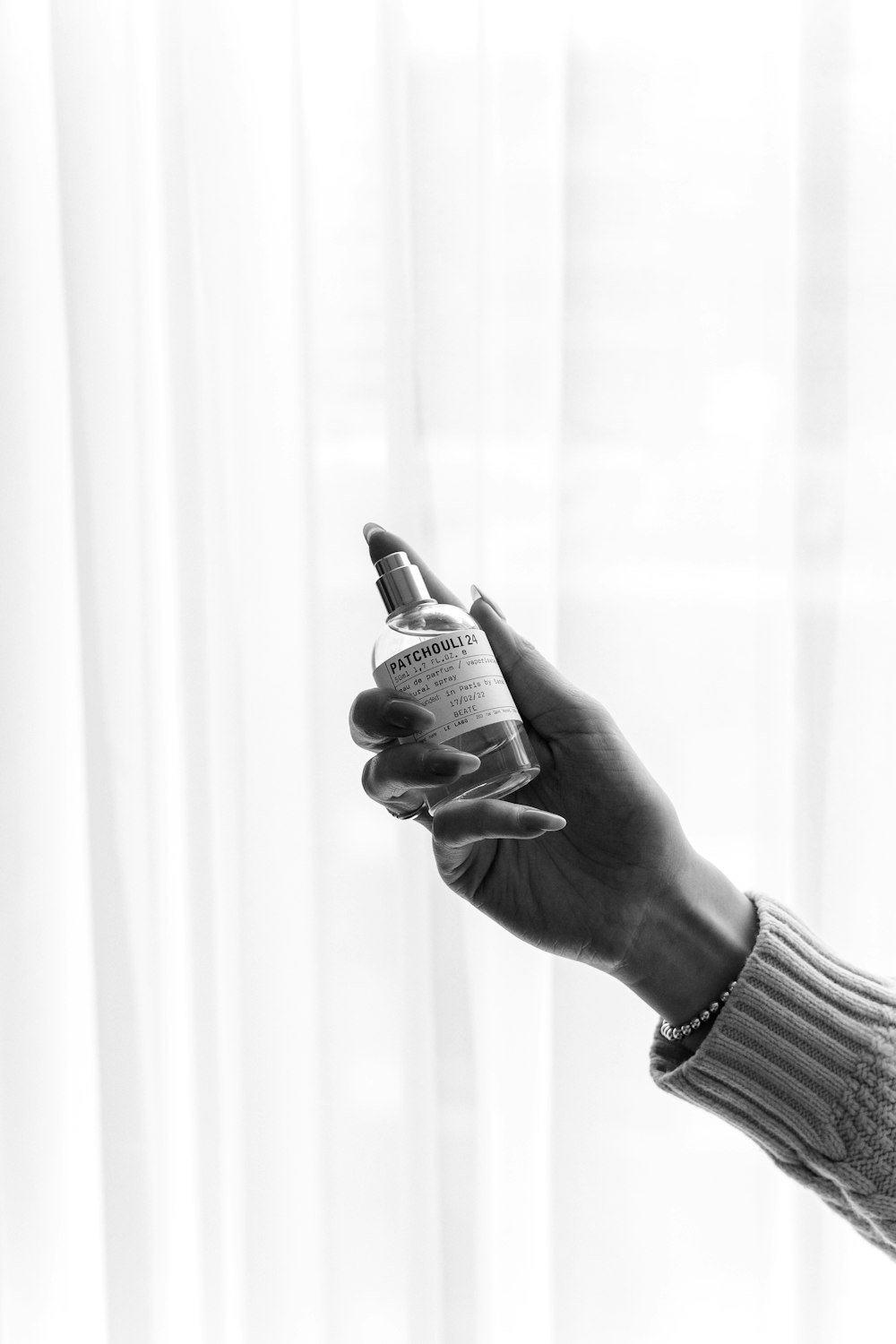 a woman holding a bottle of alcohol in her hand