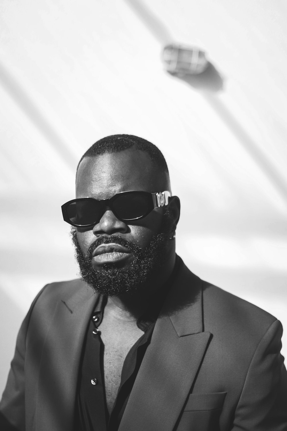 a man in a suit and sunglasses posing for a picture