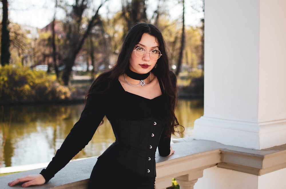 a woman in a black dress posing for a picture