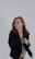a woman in a black jacket is posing for a picture
