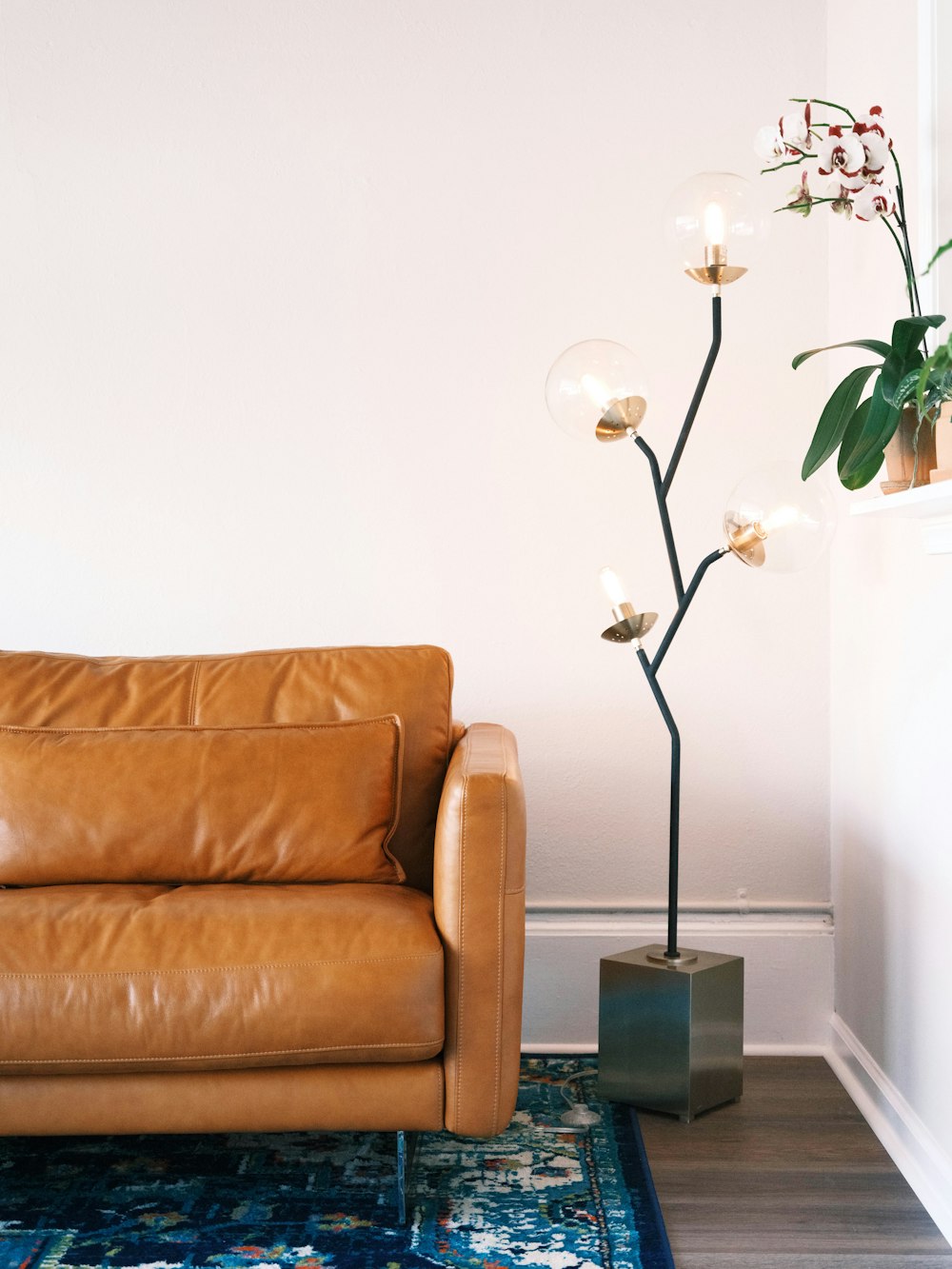 a living room with a couch and a lamp