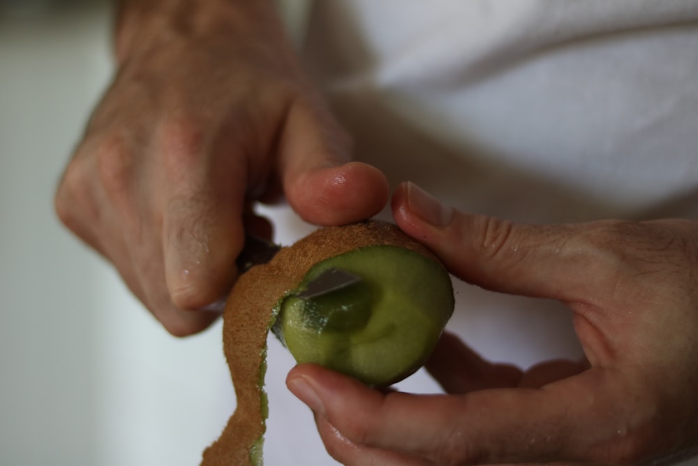 a person holding a piece of food in their hands