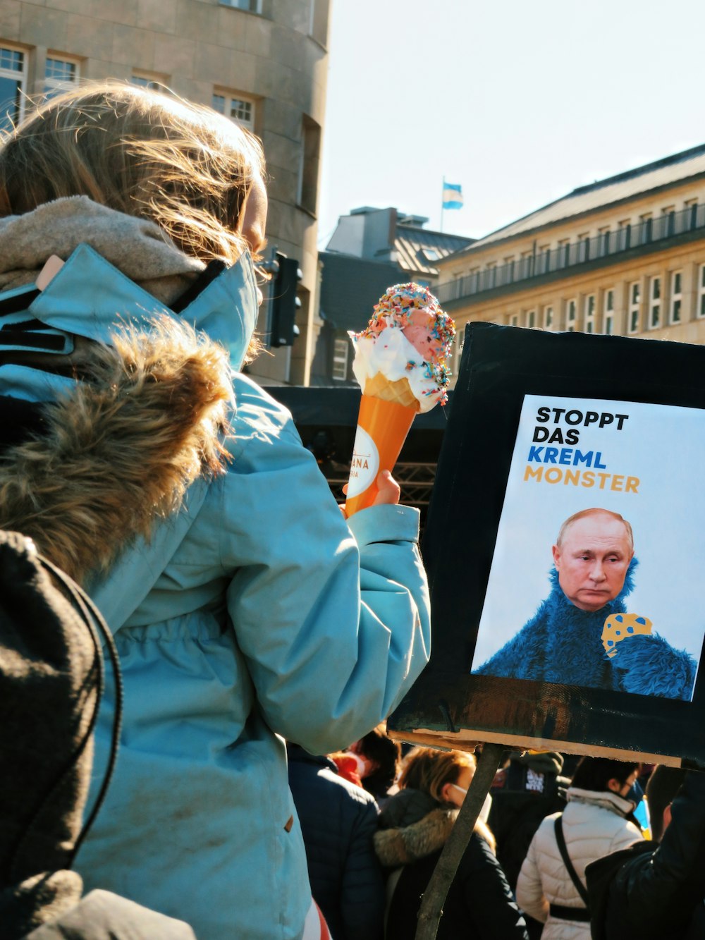 a person holding up a sign with a picture of a man holding an ice cream