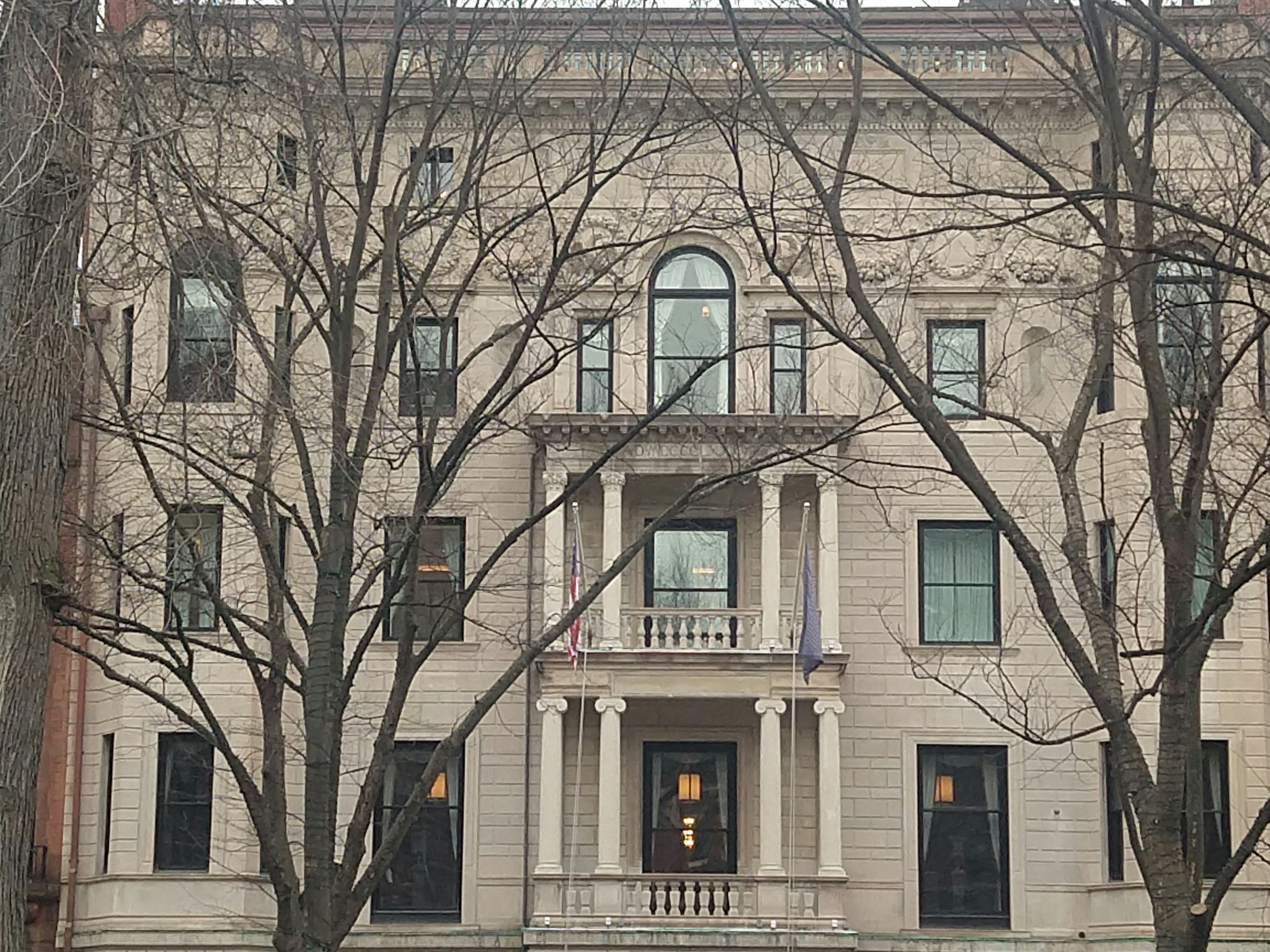 A large white building with a clock on the front of it