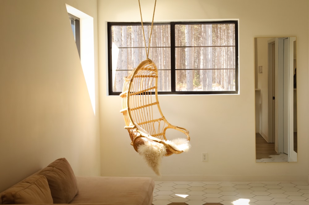 a hammock hanging from a window in a living room