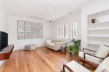 A clean and modern living room showcasing a polished floor and minimalistic decor.