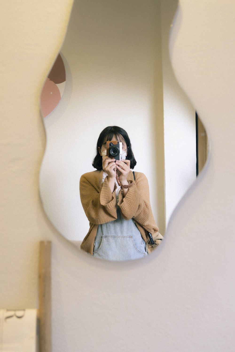 a woman taking a picture of herself in a mirror