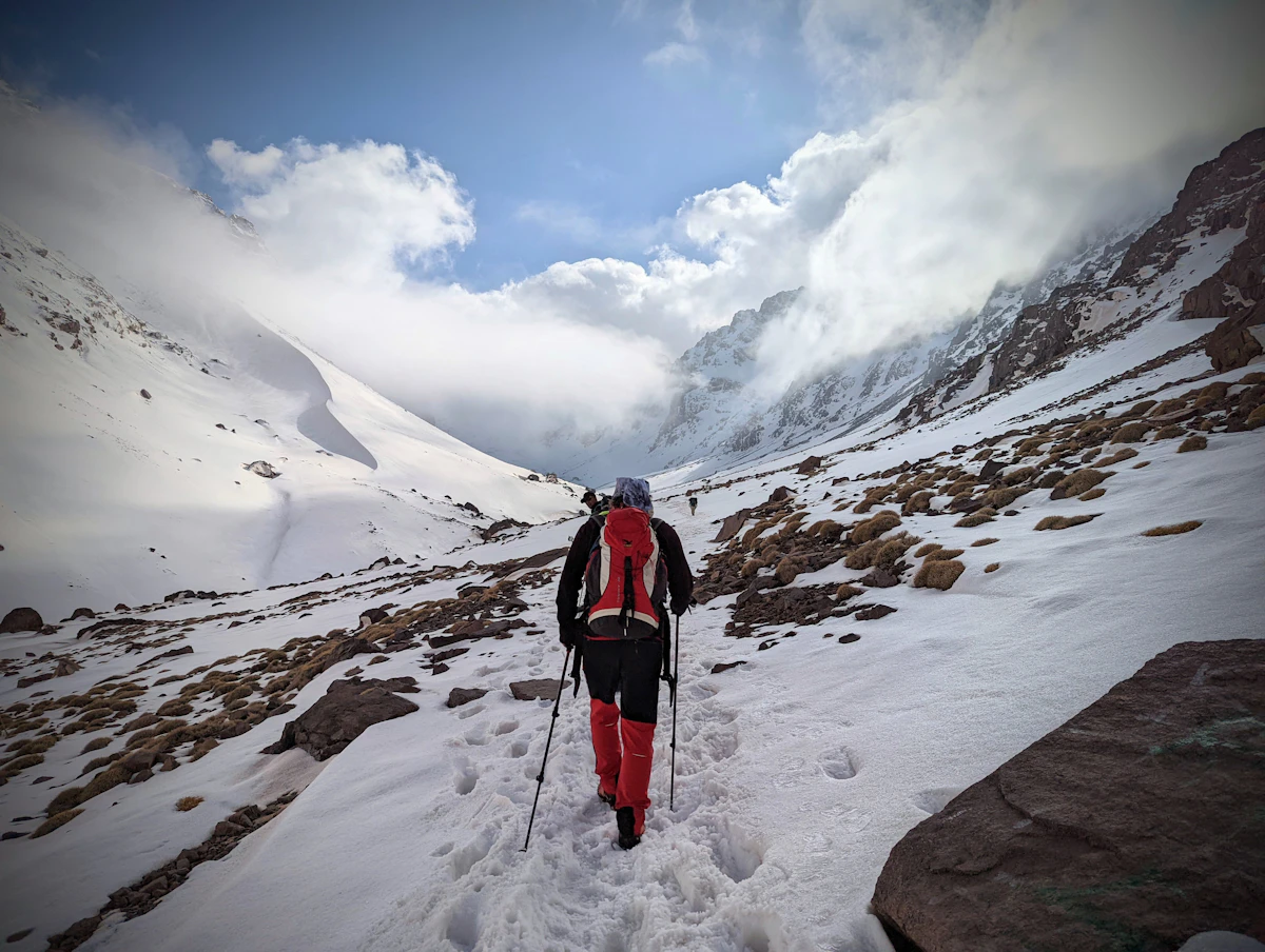 Mountaineer ascending the snowy slopes of Mount Toubkal, Morocco