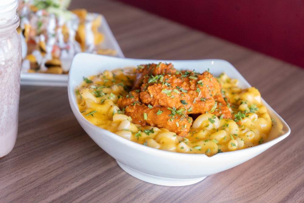 a bowl of macaroni and cheese with meatballs