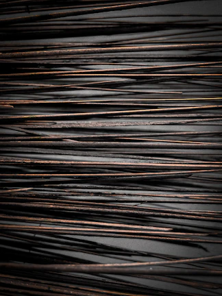 Geopathic rods resting on a rustic surface, ready for use in balancing home energies.