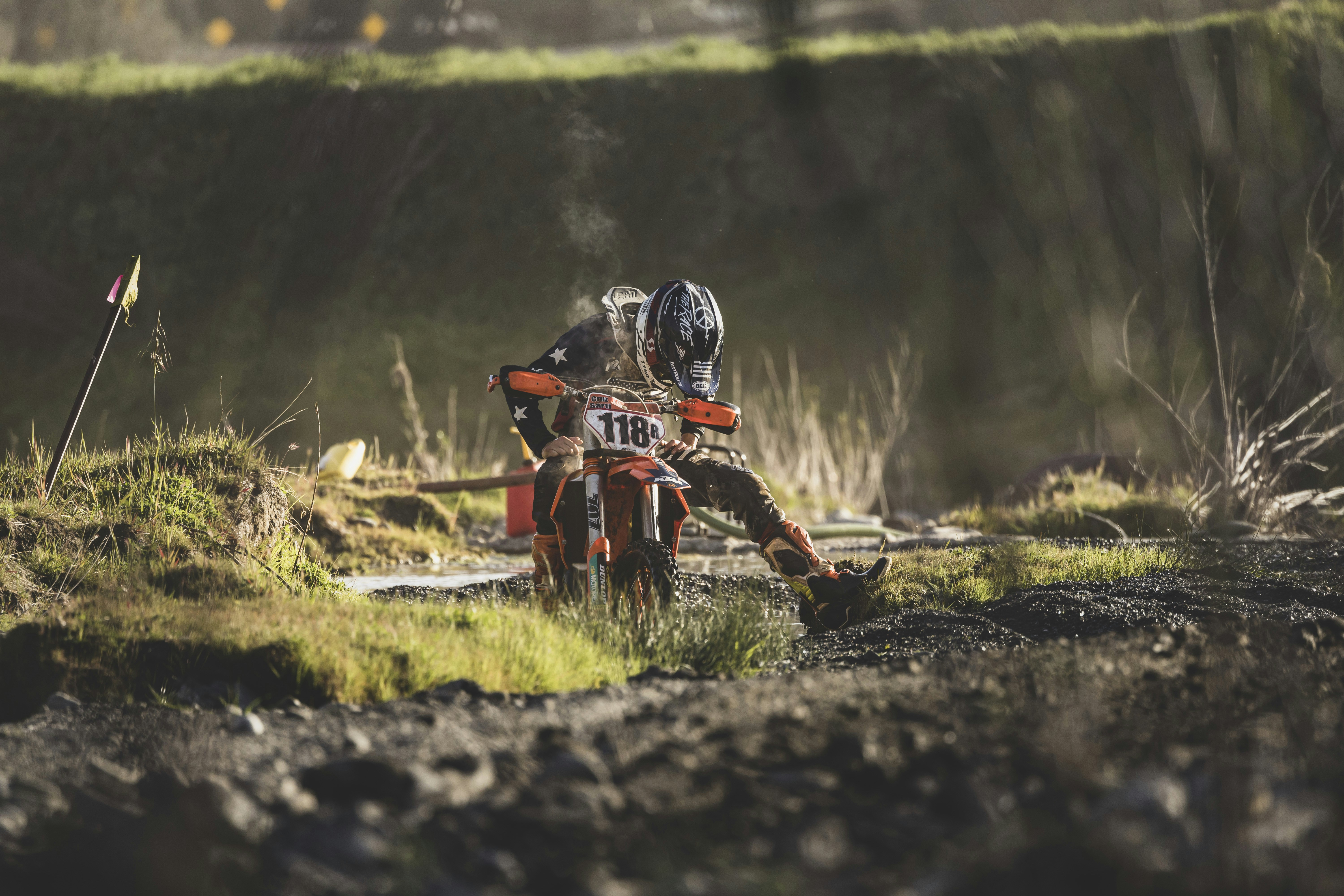 a couple of people riding on the back of a dirt bike