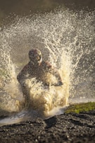 Electric motorcycle riding through puddles, splashing water without any damage
