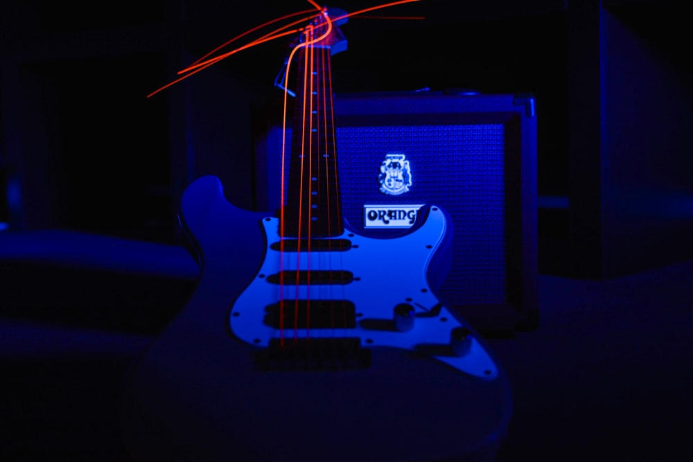 a guitar and amp in a dark room