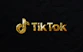 A vibrant TikTok logo glowing with purple and gold accents on a dark background.