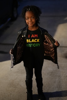 a young girl wearing a t - shirt that says i am black history