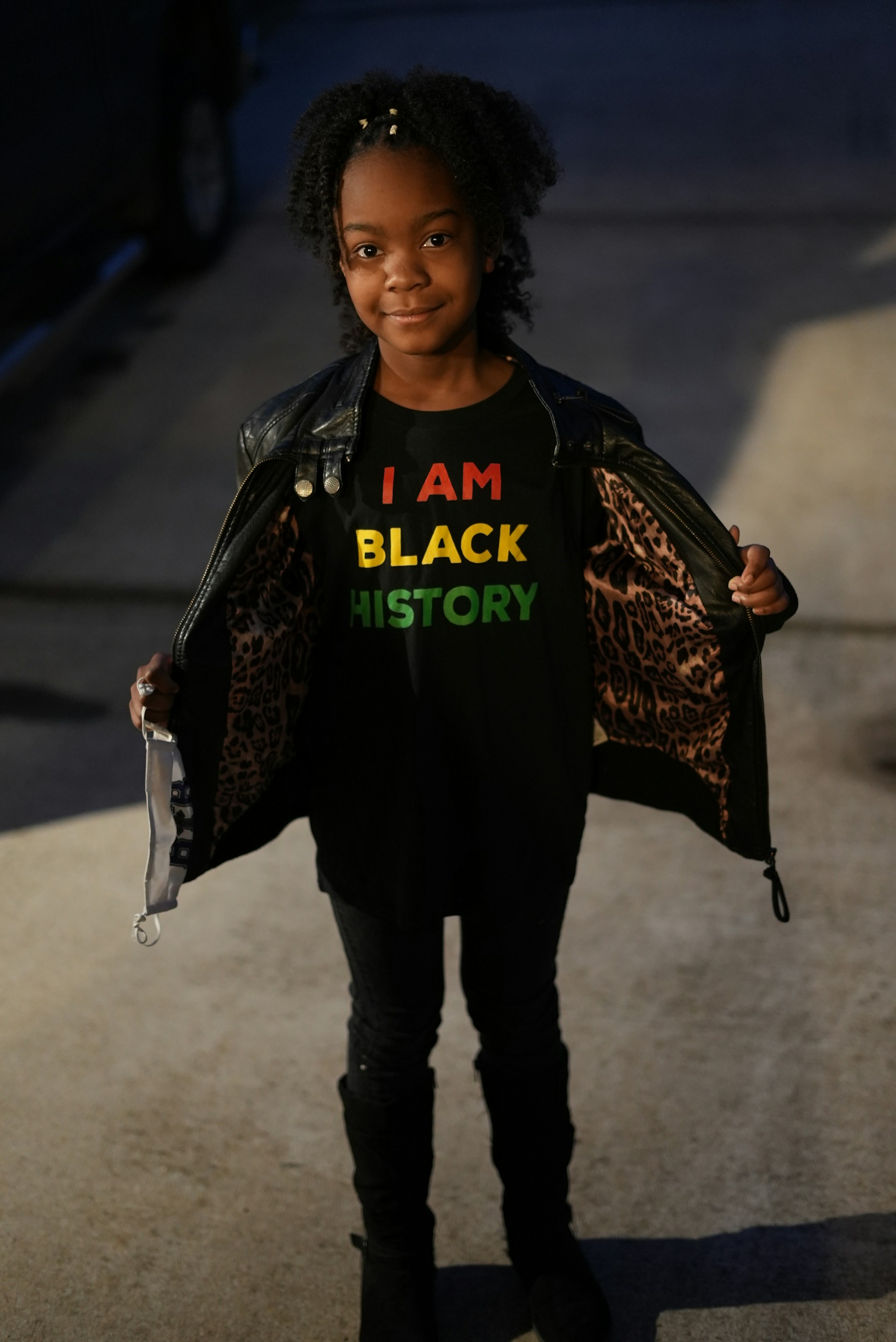 a young girl wearing a t - shirt that says i am black history
