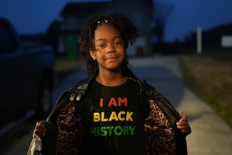 a girl with a t - shirt that says i am black history