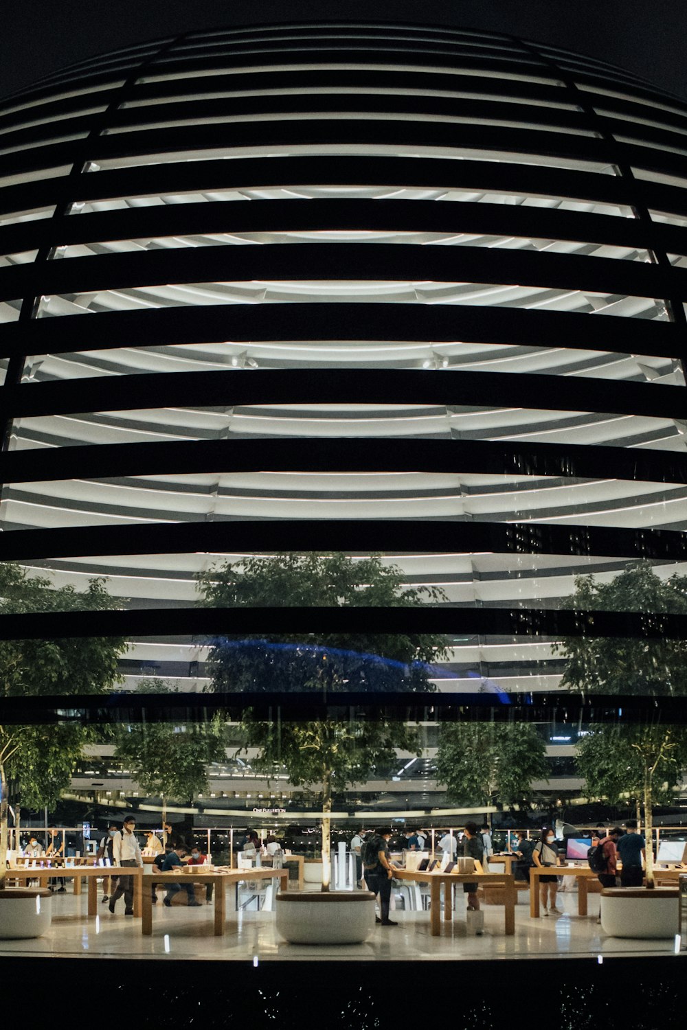 a group of people sitting at a table in front of a building