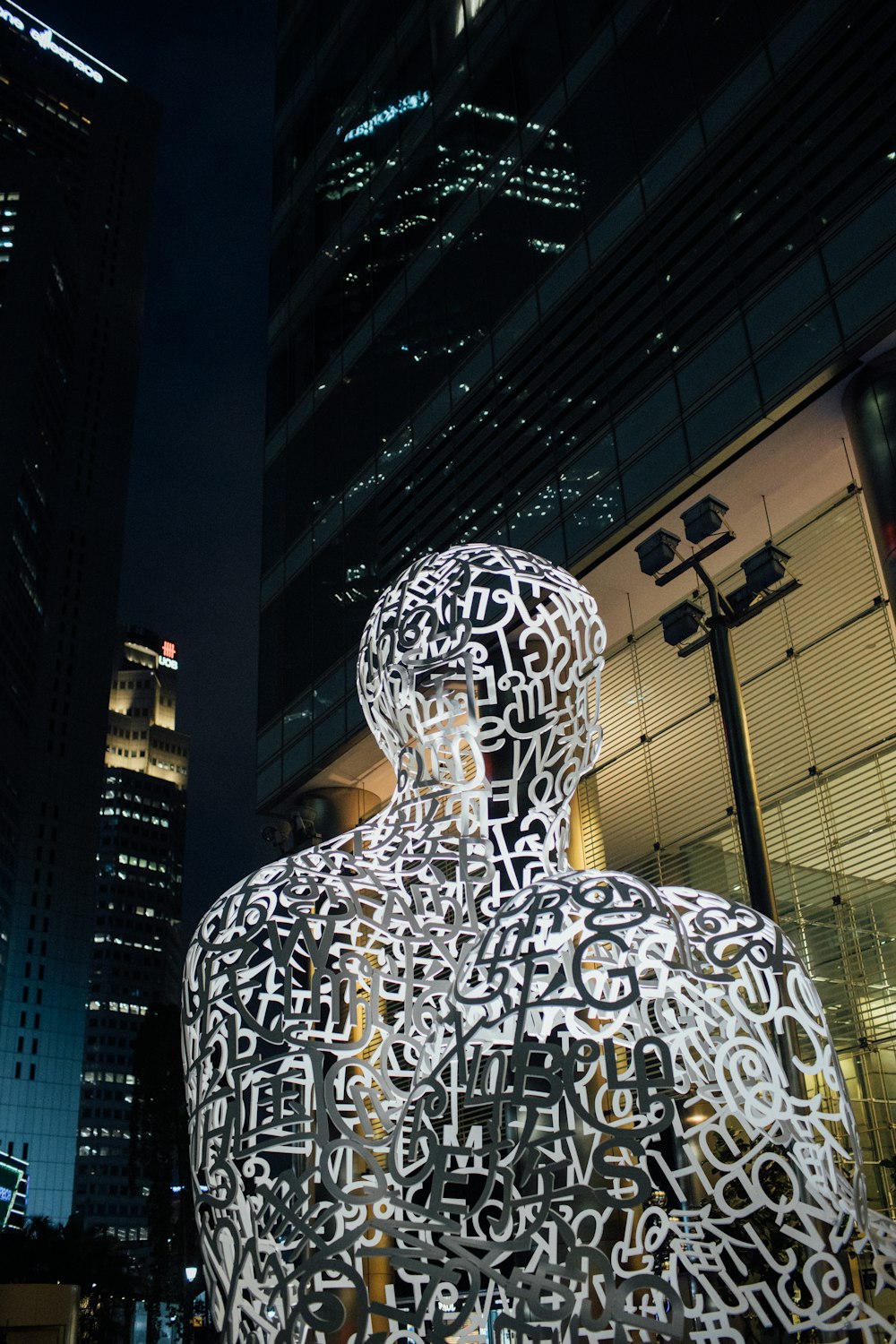 a statue of a man in a city at night