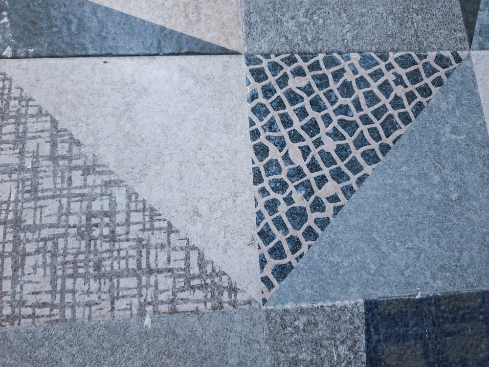 a close up of a tile floor with a design on it