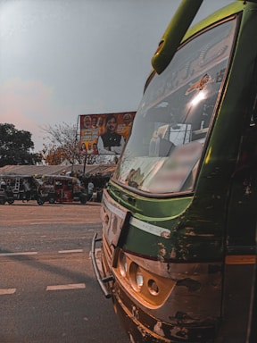 Front view of Sri Lakshitha Travels office with a fleet of diverse vehicles parked outside.